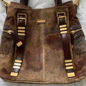 Michael Kors distressed leather bag with gold accents.